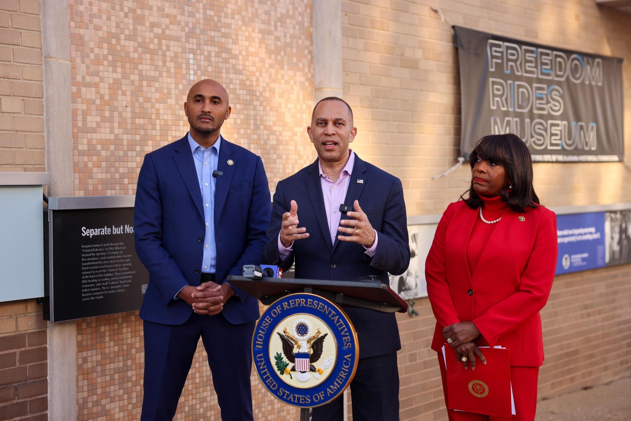 Rep. Shomari Figures (left), Leader Jeffries (center) and Rep. Terri Sewell speaking at a press conference outside of the Freedom Rides Museum