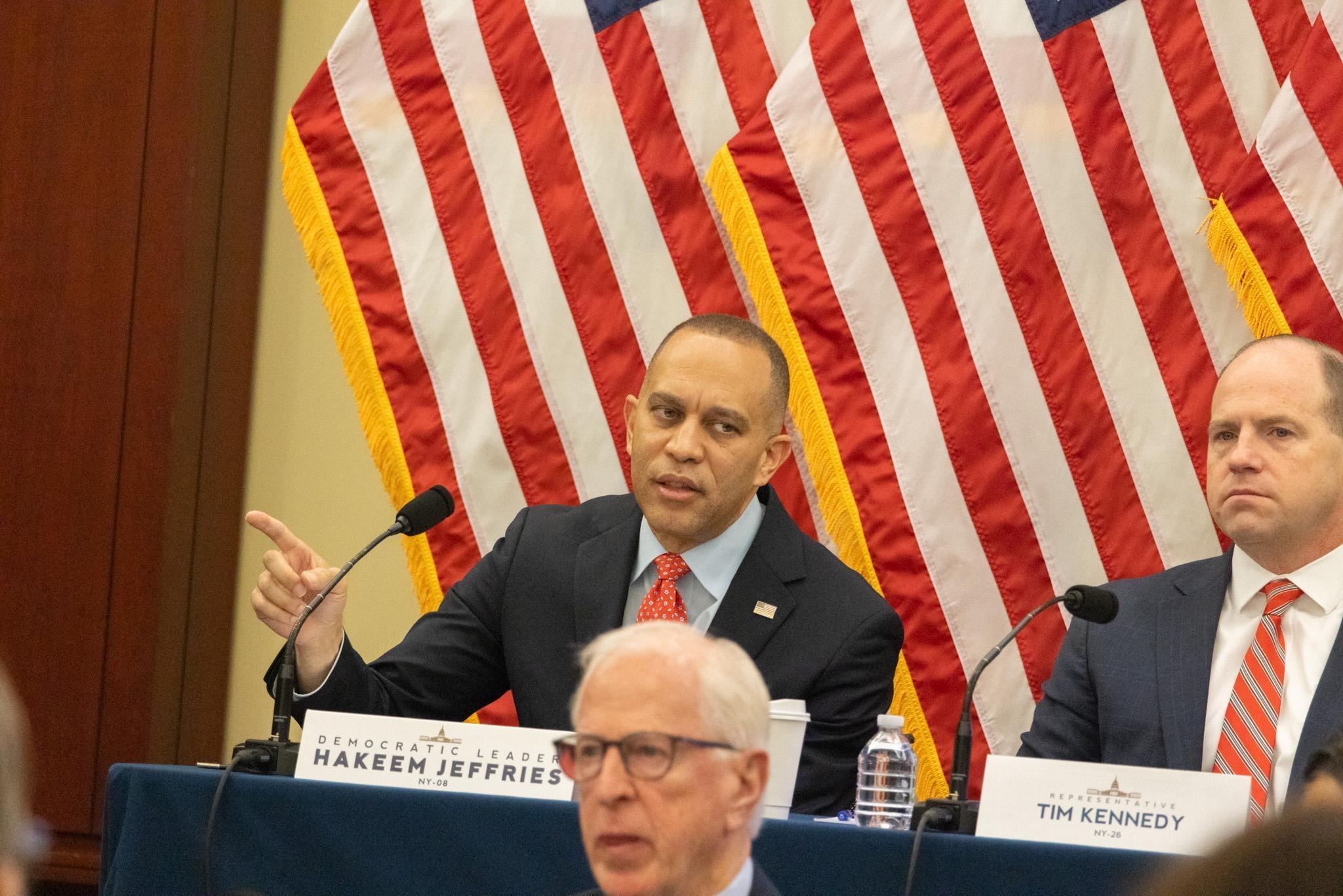 Leader Jeffries seated on a dais and speaking at Steering and Policy Committee Hearing