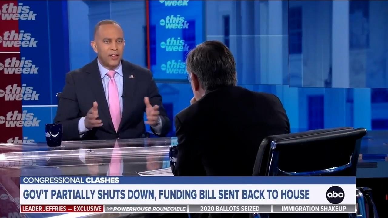 Leader Jeffries (left) and George Stephanopoulos (right) seated across from each other at a glass table