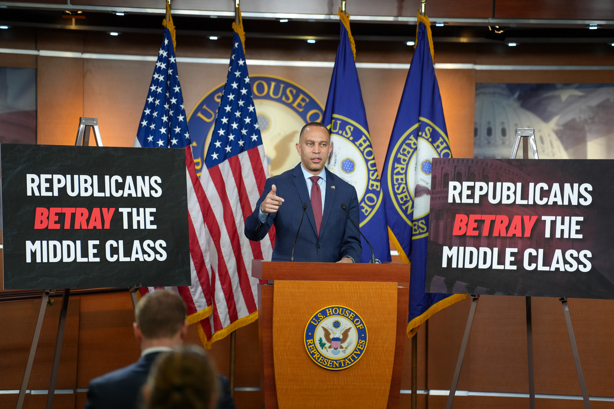 Leader Jeffries Speaking at Weekly Press Conference with posters on his left and right reading "Republicans Betray the Middle Class"