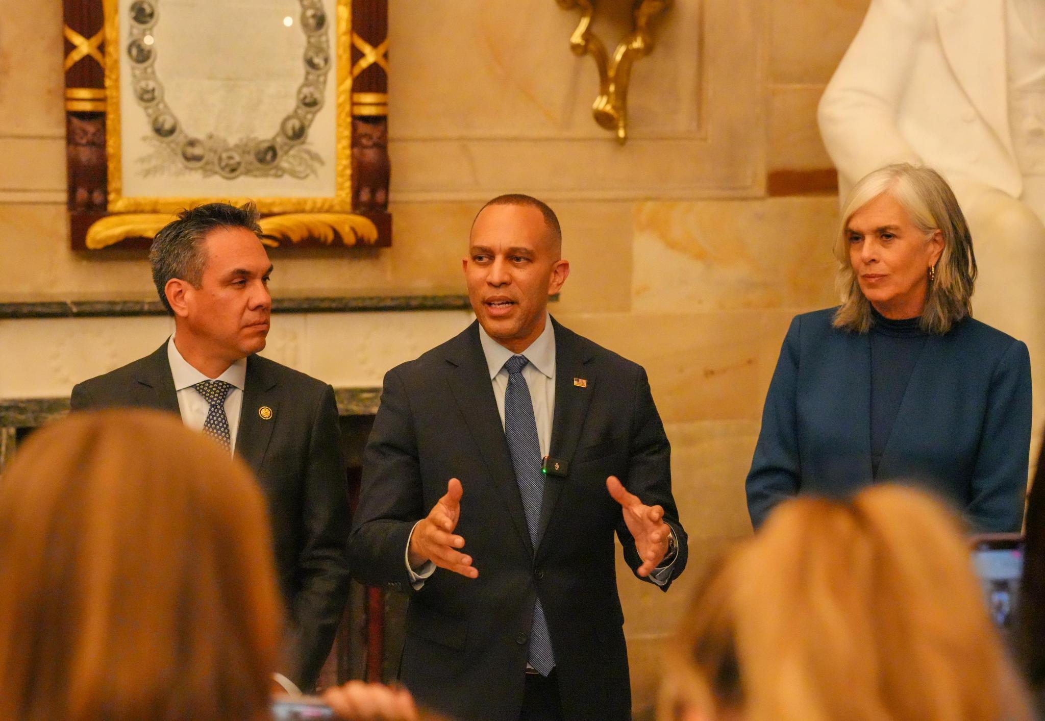Leader Jeffries (center), Whip Katherine Clark (right) and Chair Pete Aguilar (left) speaking at Statuary Hall gaggle
