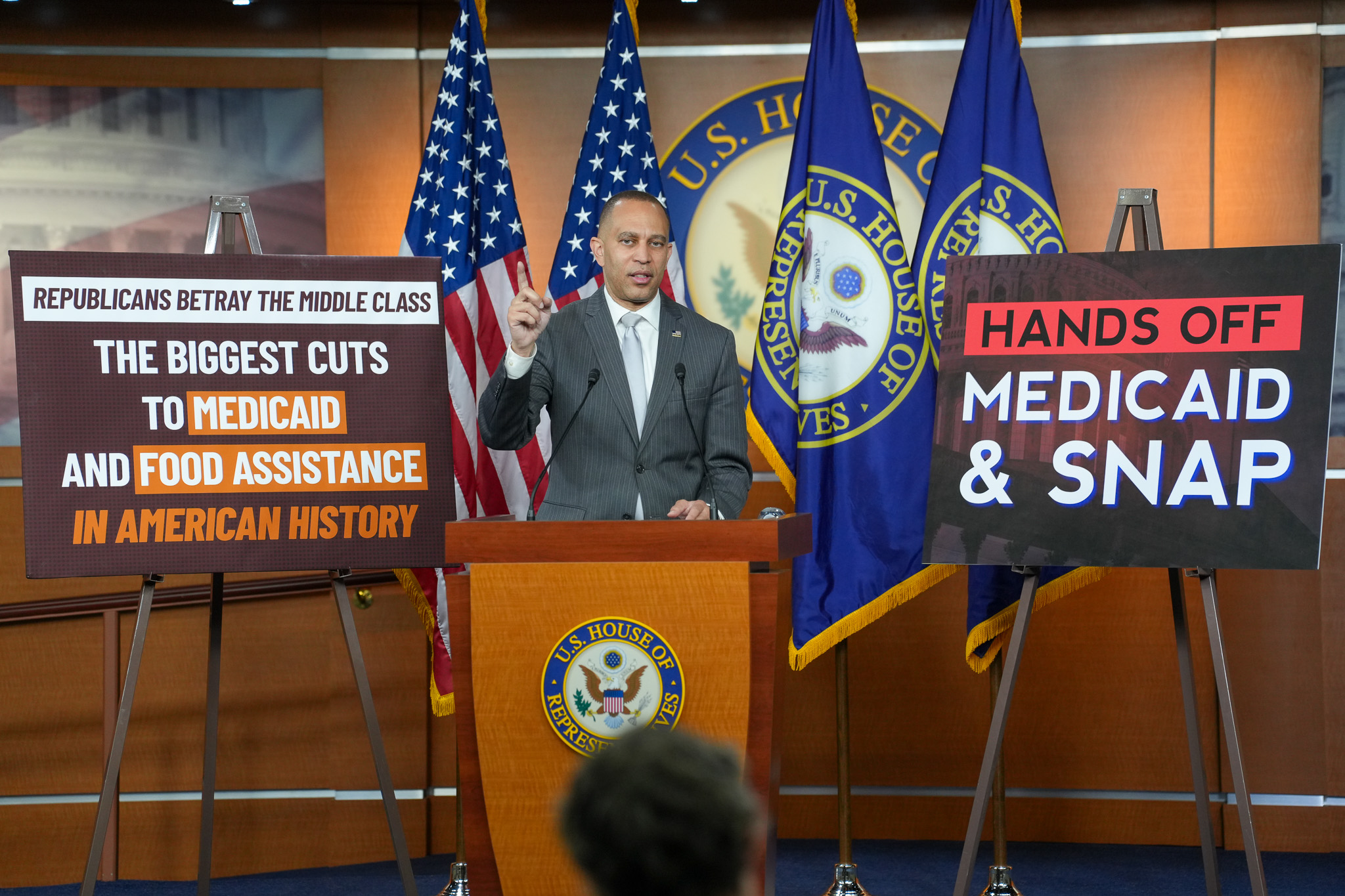 Leader Jeffries Speaking at Weekly Press Conference next to signs reading "Republicans Betray the Middle Class: The Biggest Cuts to Medicaid and Food Assistance in American History" and "Hands Off Medicaid and SNAP"