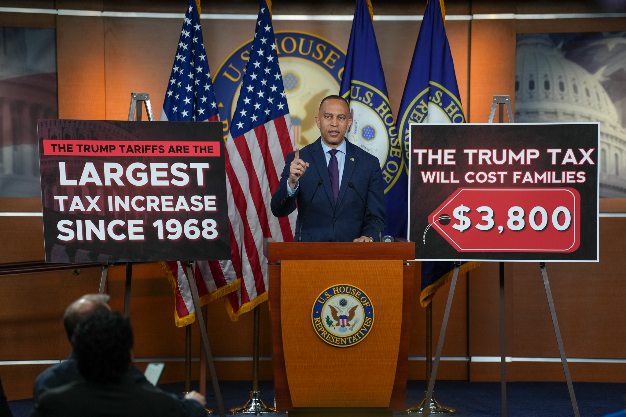 Leader Jeffries Speaking at Weekly Press Conference between signs reading "The Trump Tariffs Are the Largest Tax Increase Since 1968" and "The Trump Tax Will Cost Families $3,800"