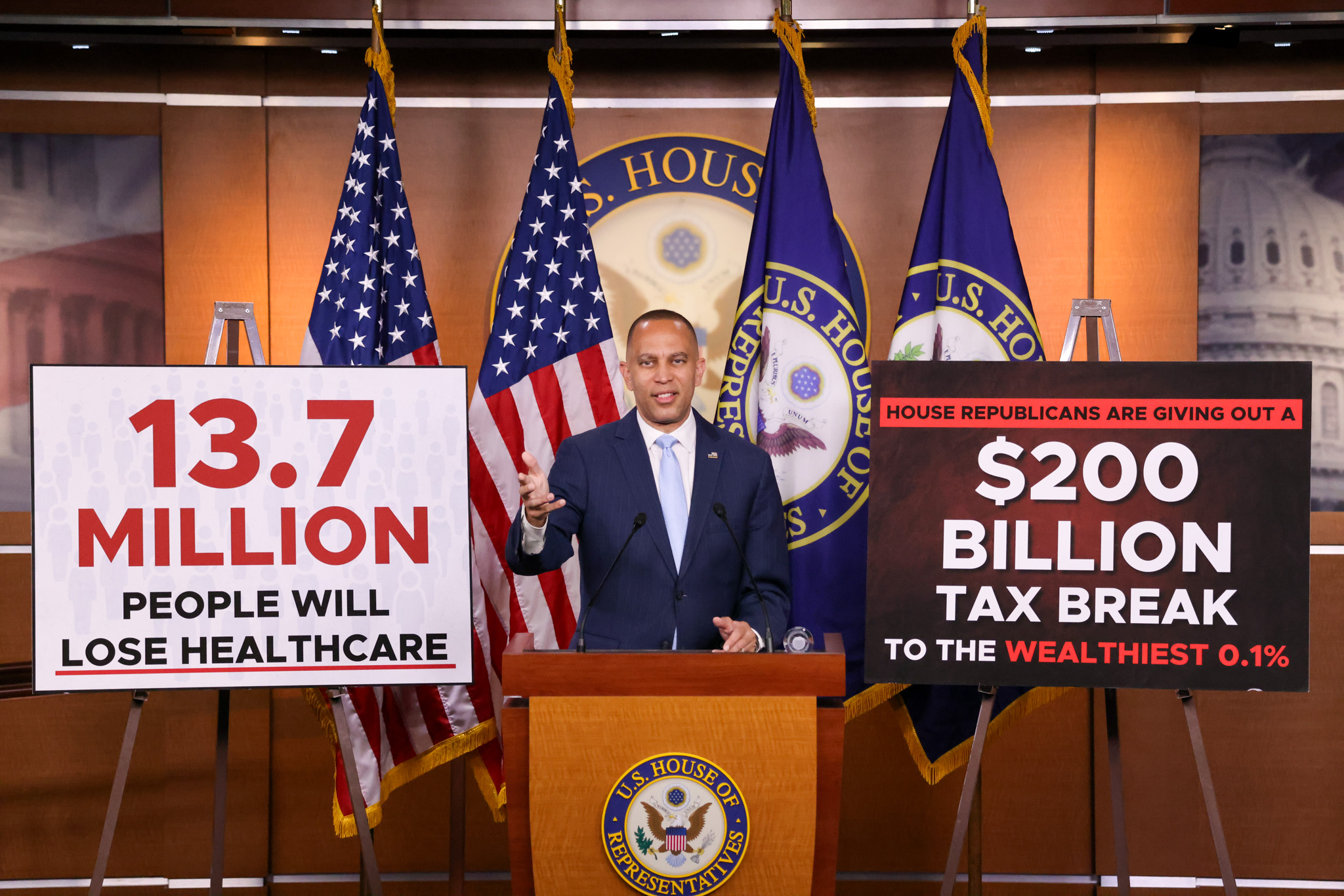 Leader Jeffries Speaking at Weekly Press Conference in between signs reading "13.7 Million People will Lose Healthcare" and "House Republicans are Giving Out a $200 Million Tax Break to the Wealthiest 0.1%"