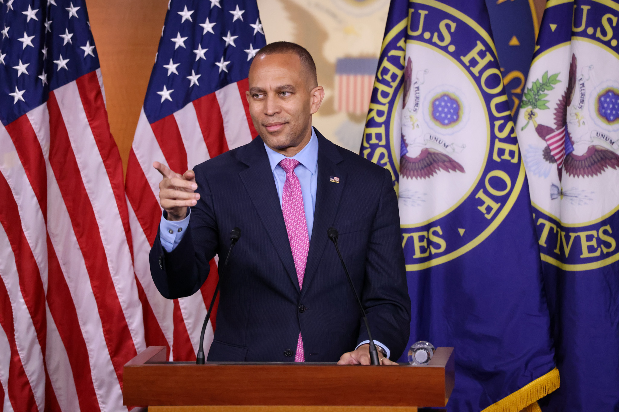 Leader Jeffries speaking at Weekly Press Conference in front of American and House of Representatives flags