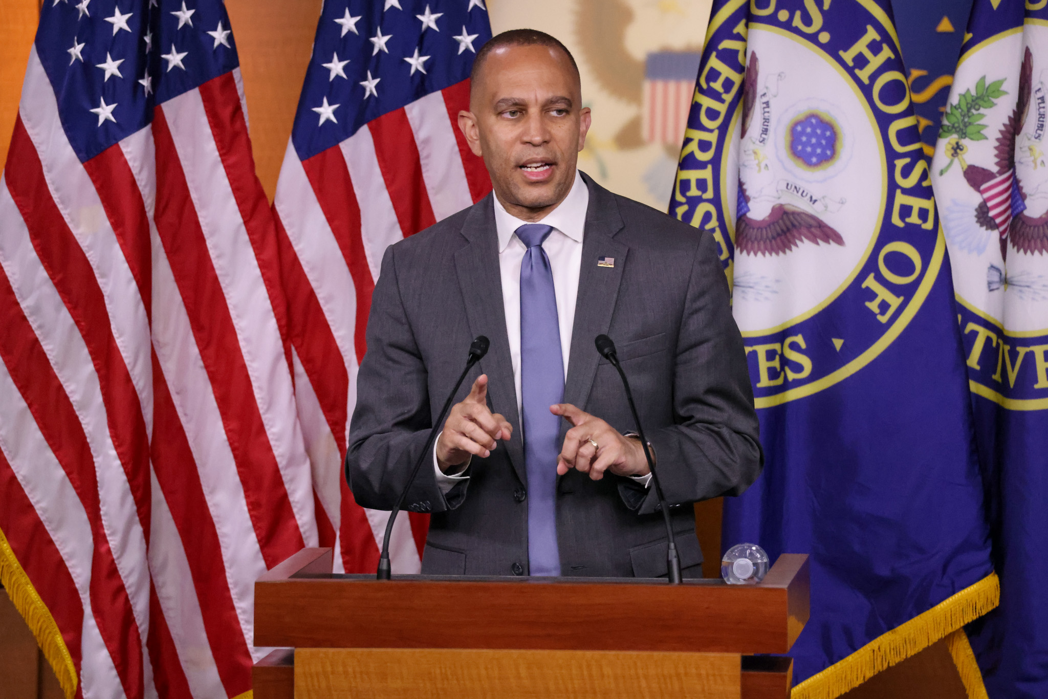 Leader Jeffries Speaking at Weekly Press Conference in front of American and House of Representatives flags
