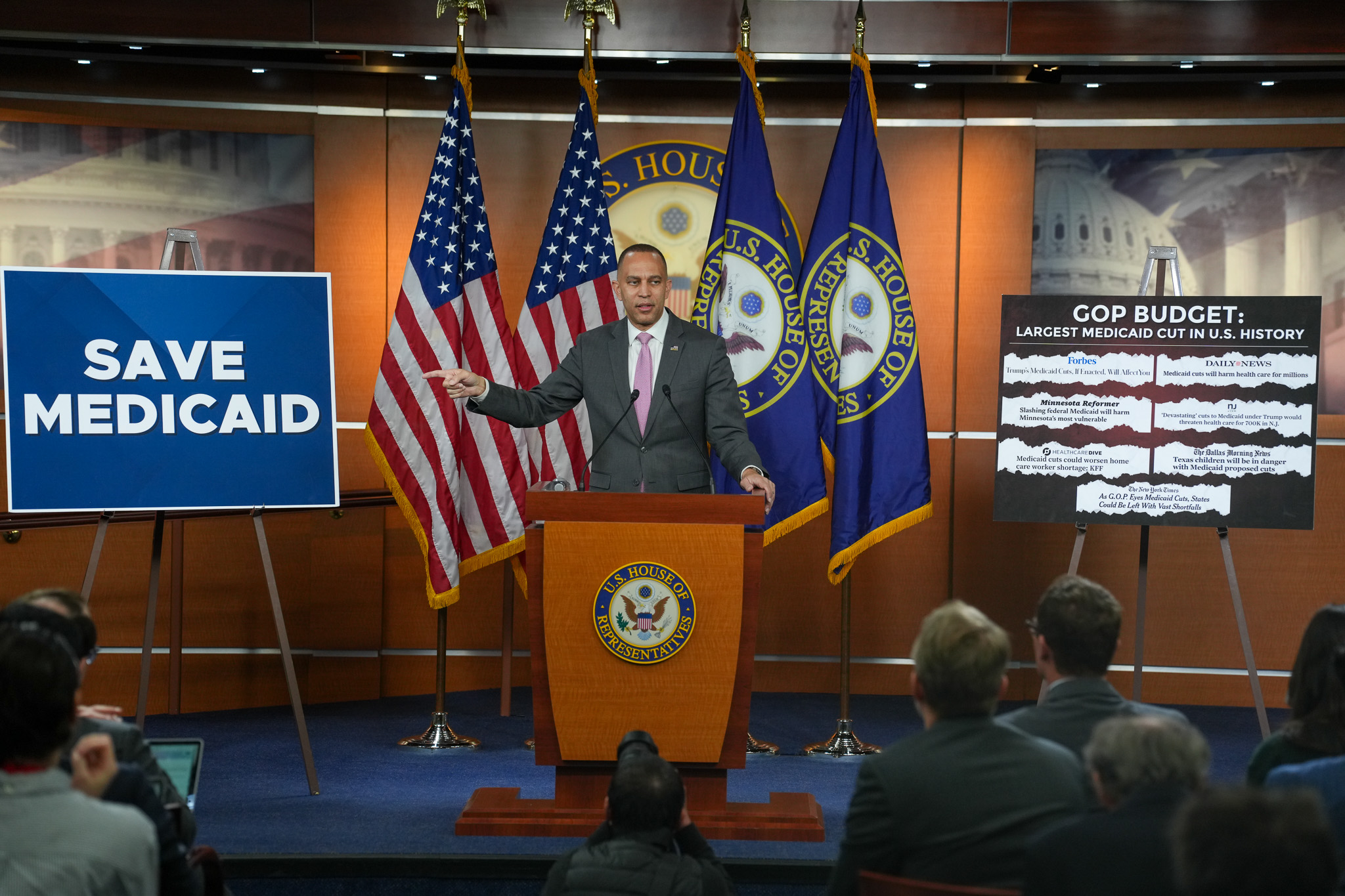Leader Jeffries speaking at weekly press conference with signs reading "save Medicaid" and headlines about House Republicans' budget