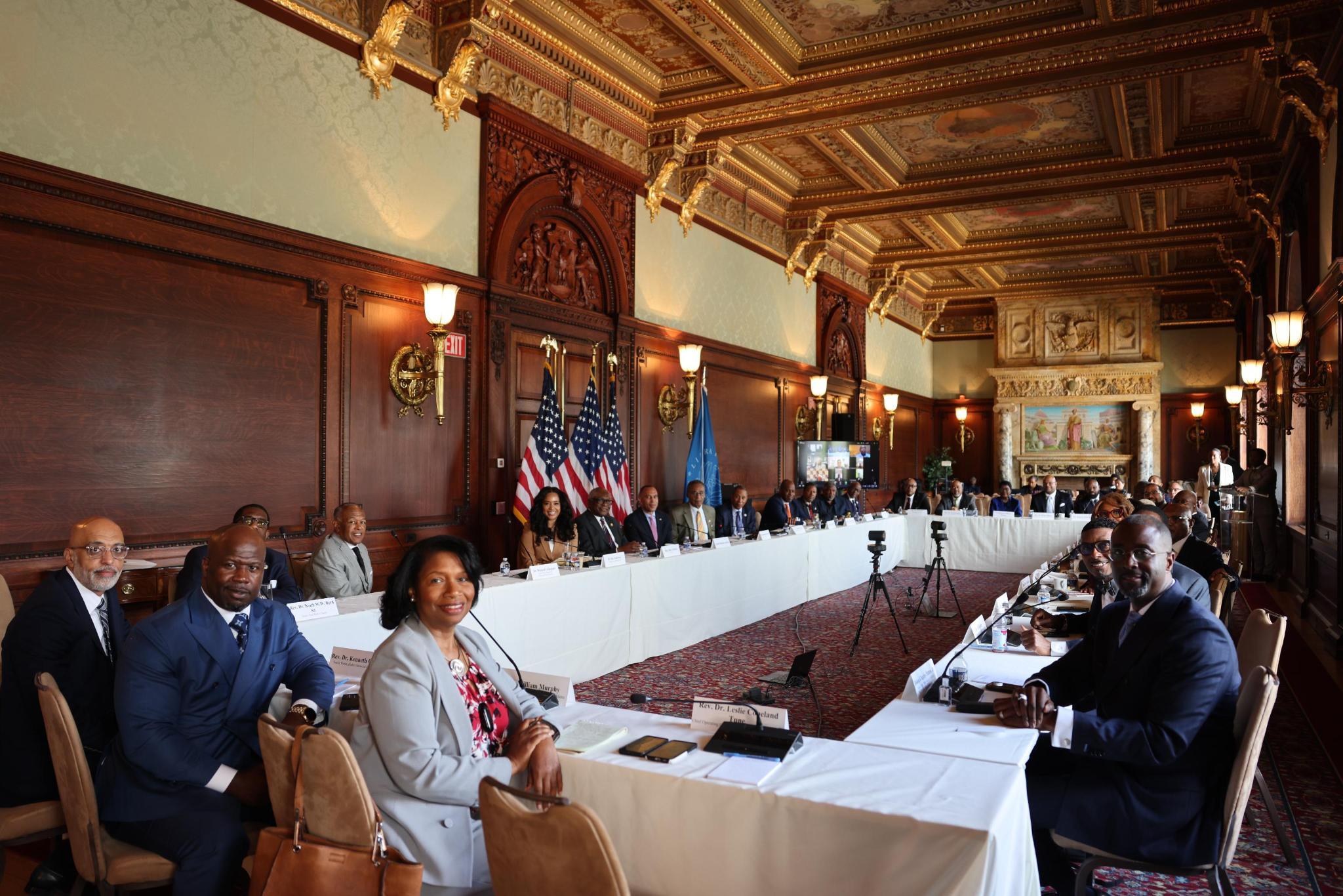 Group photo of clergy sitting around a table, joined by Leader Jeffries, Rep. James Clyburn and Rep. Emanuel Cleaver