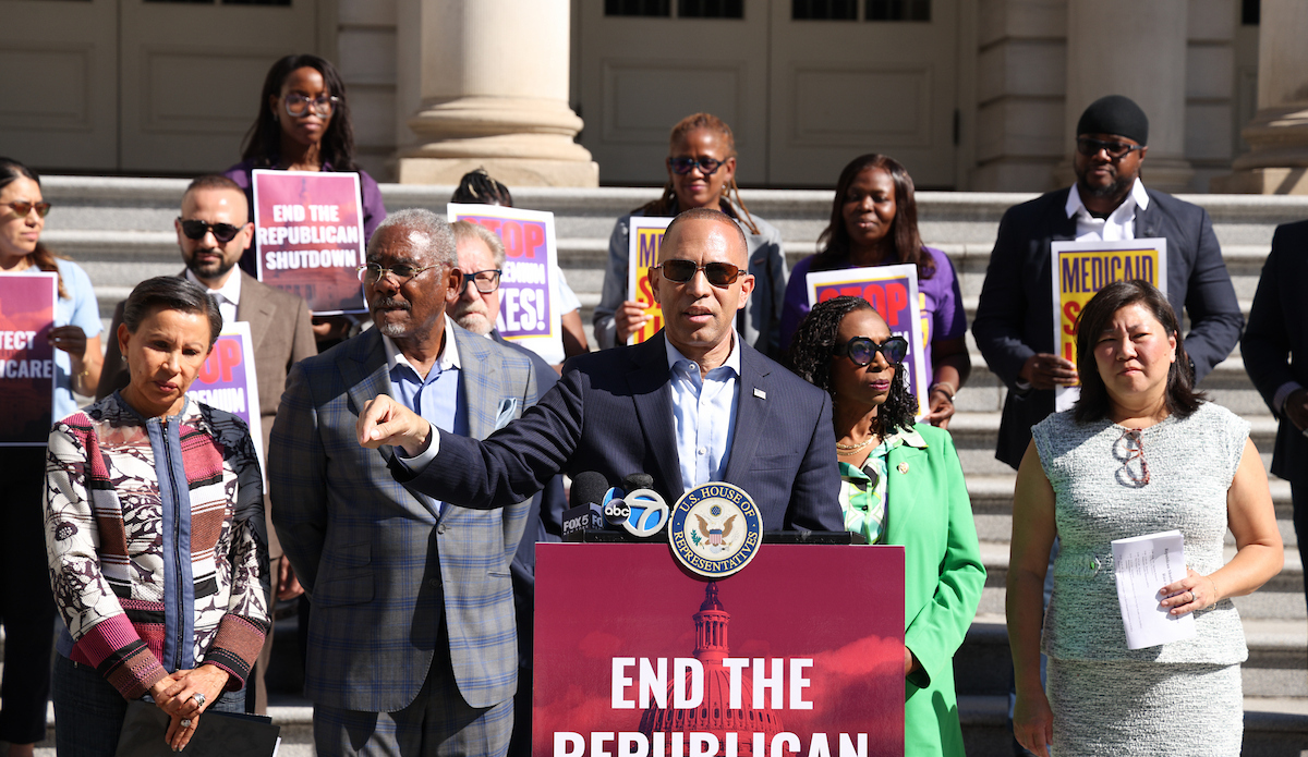 Leader Jeffries (center) speaking on the steps of City Hall with members of the New York City congressional delegation