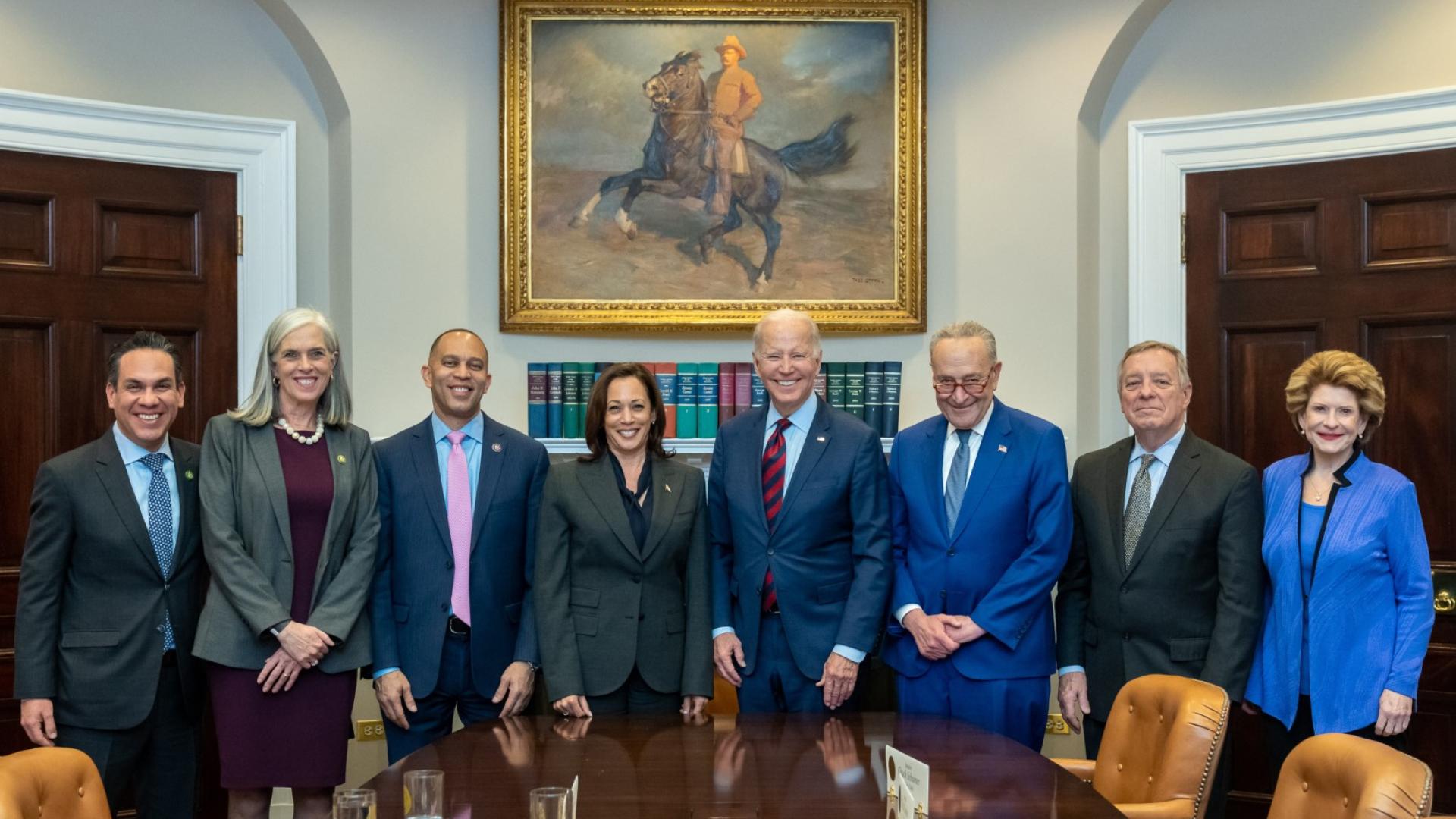 Standing with democratic leaders, the President, and Vice President