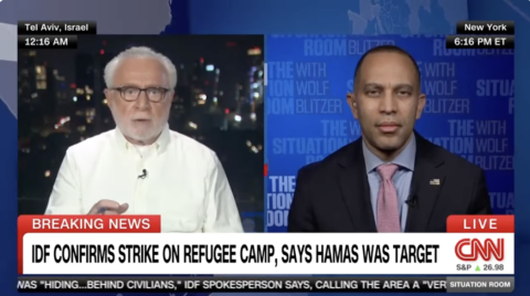 Leader Jeffries (left) appearing on screen with Wolf Blitzer (right)