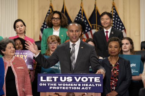 Leader Jeffries speaking at press conference, flanked by advocates and members of the House Democratic Caucus