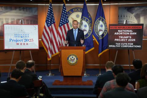 Leader Jeffries Speaking at Weekly Press Conference with a poster reading 'Project 2025 Week' and a poster reading 'House Republican Agenda: National Abortion Ban | Trump's Project 2025 | Tax Cuts for Wealthy Corporations'