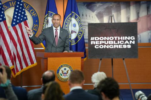 Leader Jeffries Speaking at Weekly Press Conference with a poster reading 'Do Nothing Republican Congress'