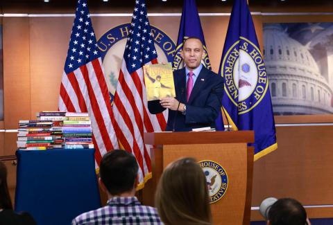 Leader Jeffries holding up a copy of a children's book titled "Roberto Clemente: Pride of the Pittsburgh Pirates"