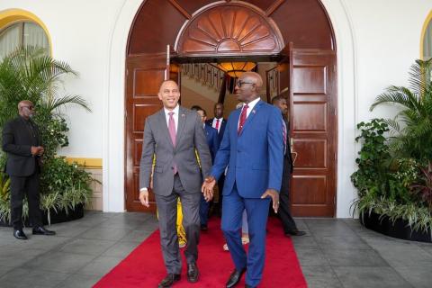 Leader Jeffries (left) and PM Keith Rowley (right) walking together